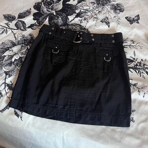 Black mini skirt with utility-style cargo pockets & silver grommet hardware